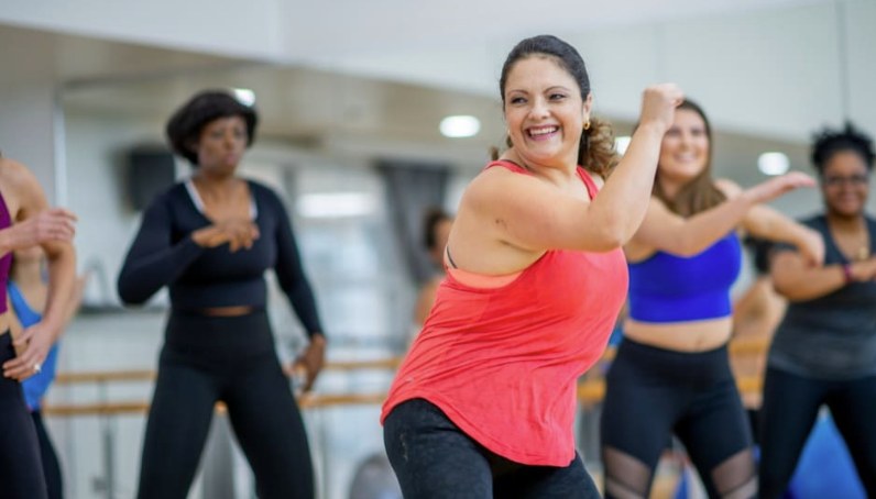 A group of women mid-workout in a fitness class